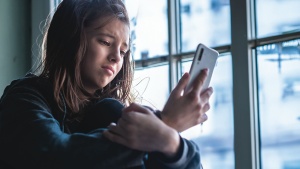 A teenager looking at her phone.