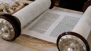 a Hebrew scroll rolled partially open to reveal text