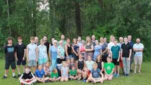 a large group of campers and staff gathered outdoors