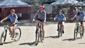 four teenage girls riding bicycles