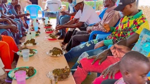 a group of people seated at a table outdoors