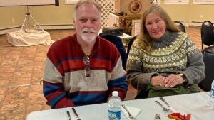 a man and a woman seated at a table indoors