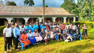 a large group of people standing and seated outdoors