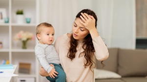 a stressed woman holding a small child