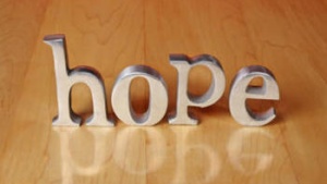 The letter HOPE on a table.