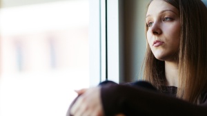 A young woman sitting by herself.