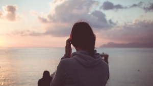 A young woman looking at water.