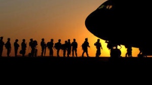 Soldiers boarding an airplane.