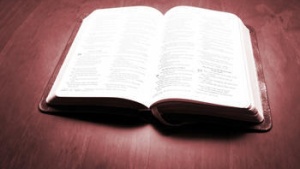 A open Bible laying on a table.