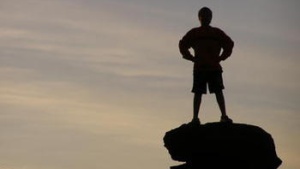 boy standing on a rock