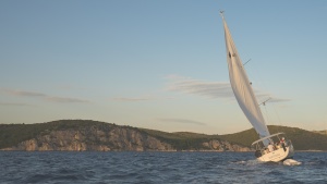 A sailboat leaning into the wind.