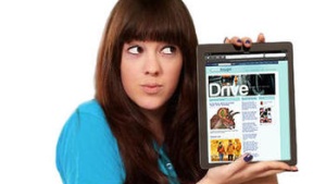 A teen girl holding an iPad showing the Vertical Thought website.