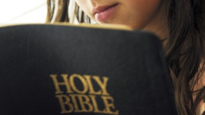 A woman reading a Bible.