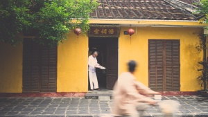 A person standing by their house.