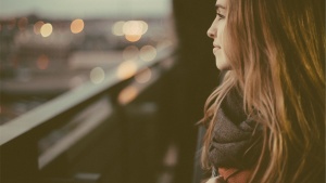 A woman looking out over a busy city.