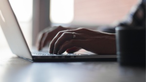 A person typing on a laptop.