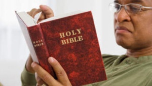 A man reading a Bible.