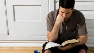 A man sitting and reading the Bible.