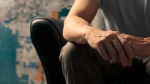 Man sitting in leather chair.