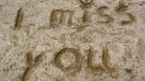 words I miss you written in sand