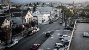 View from the top of building looking down at a city street.