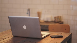 A laptop and smartphone on a table.