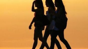 three girls walking in sunshine