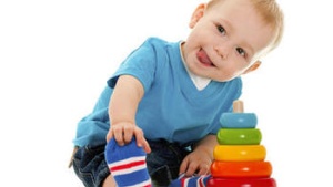 A baby playing with a stacking ring toy - Rock-a-stack