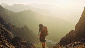 A person a top of a mountain peak.