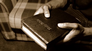 A man holding a Bible.