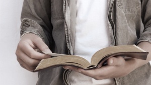 A man reading a Bible.