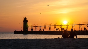 Sunset over a pier going into the ocean.