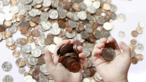 child's hands holding coins