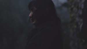 Dark clouds in the sky above a woman.