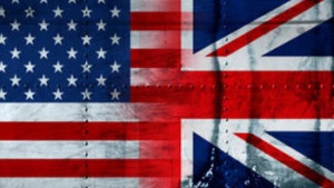 United States and Great Britain flags painted on steel looking background.