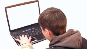 teenage boy using laptop computer