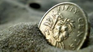 coin buried in sand