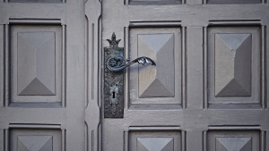 Old door with ornate handle and key hole.