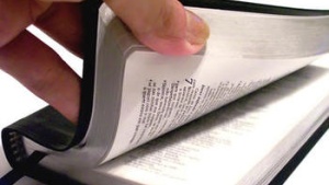 hand opening Bible