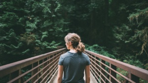 A young woman walking by herself.