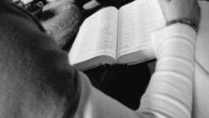 A young man reading his Bible.