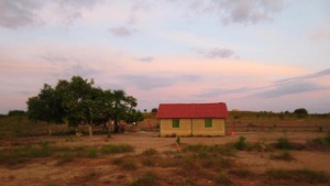 Red and yellow house in farmland