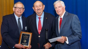 Top: Victor Kubik and Dr. Donald Ward recognize earl Roemer for 50 years of service in the ministry.