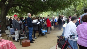 Church members sing hymns at services in the park. 