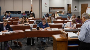 The 17 new students fill out information sheets during ABC registrar Steve Myers’ presentation during orientation.