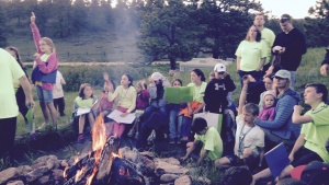 Campers and staff around the fire. 