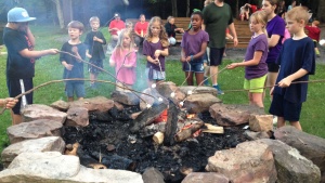 Campers roasting marshmallows. 