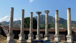 Pillars still stand at the site of the ancient city of Sardis.  Behind them, the famous acropolis rises into the sky.