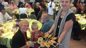 Sweet treats were part of the annual senior citizens appreciation brunch in Fort Wayne the Sabbath of Aug. 8. Montana Hermann, assisted by Tiffany Borton, were part of the serving crew.
