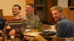 a group of three young men laughing